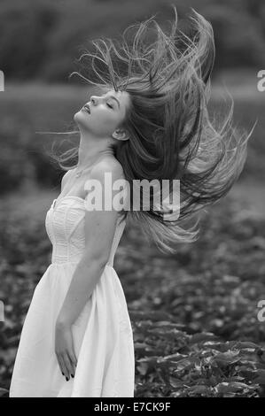 A young woman in a green field of eggplants, Kibbutz Ha'solelim, Israel Stock Photo