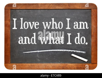 I love who I am and what I do - positive affirmation words on a vintage slate blackboard Stock Photo