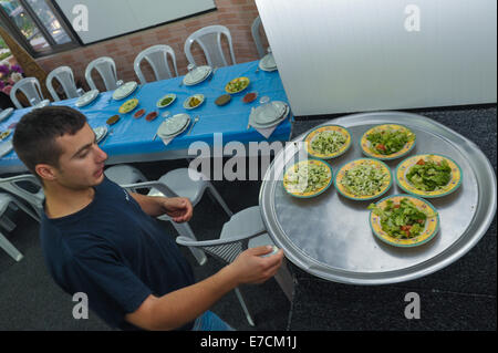 A Druze man set up table at a vacation home in the village of Hurfeish, Israel Stock Photo