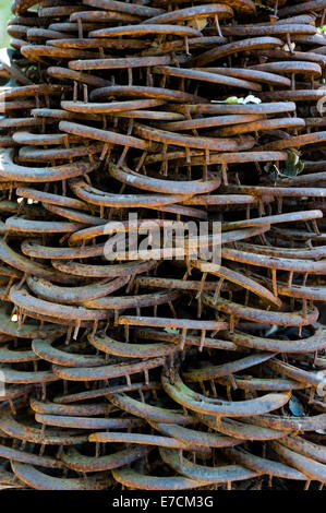 Old & used horse shoes piled up as a modern statue in an artisan shop in Los Alamos, California Stock Photo