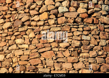 Wall built of neatly packed stone rubble of different size and shape Stock Photo