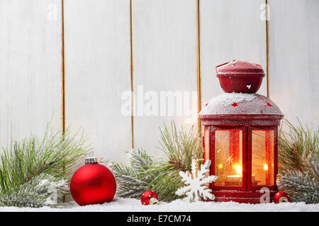 Christmas ball,lantern and fir branch on wood plank. Stock Photo