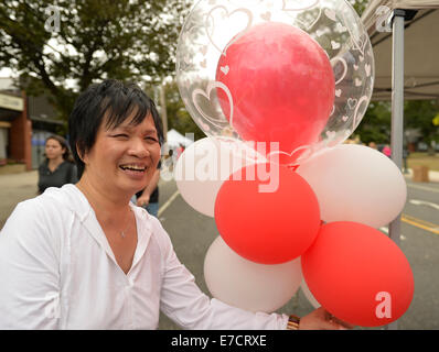 Merrick, New York, USA. 13th September 2014. Merrick Store owner Jan displays her decorative red and white balloons at the 23rd Annual Merrick Fall Festival & Street Fair in suburban Long Island. Credit:  Ann E Parry/Alamy Live News Stock Photo
