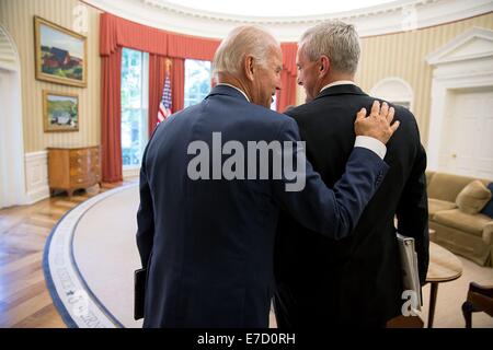 US Vice President Joe Biden talks with Chief of Staff Denis McDonough in the Oval Office of the White House July 2, 2014 in Washington, DC. Stock Photo