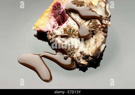 Chocolate cake dessert with berries on black plate pour hot chocolate Stock Photo