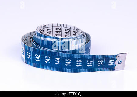 A tape measure or measuring tape is a flexible ruler on white background Stock Photo