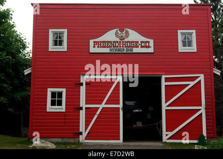 Red painted Fire station housing a 1928 Boyer fire truck at White Pine Village Stock Photo
