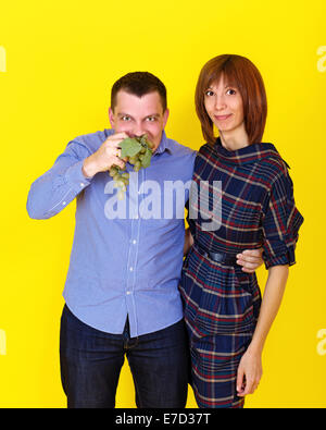 Young couple eating grapes, photographed in the studio Stock Photo