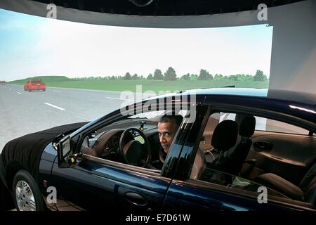 US President Barack Obama sits in the driver's seat of a vehicle simulator during a tour of the Turner-Fairbank Highway Research Center July 15, 2014 in McLean, Virginia. Stock Photo