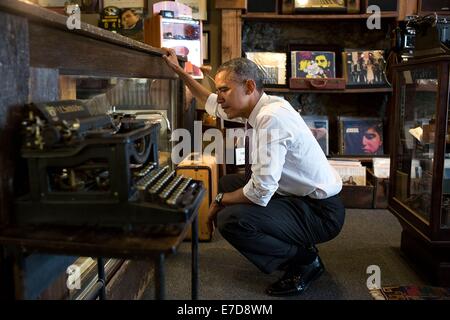 US President Barack Obama looks over merchandise in a display case at Cool Vintage Watches on Main Street July 30, 2014 in Parkville, Missouri. Stock Photo