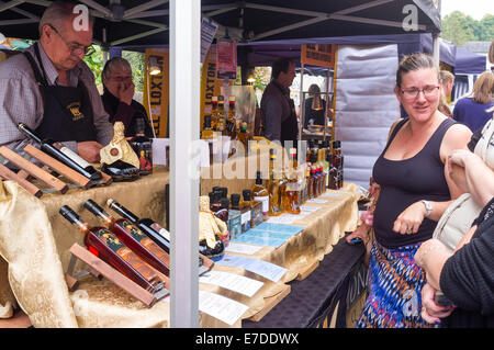 Ashburton Food & Drink Festival market stalls UK.  The Monarc Liqueur stall selling bespoke liqueurs and rare spirits. Stock Photo