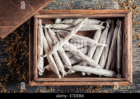 Handmade cigarettes in wooden box Stock Photo