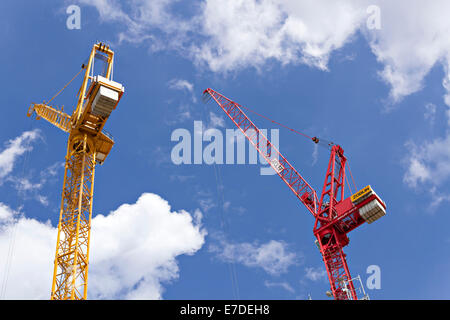 Industrial cranes against cloudy blue sky Stock Photo