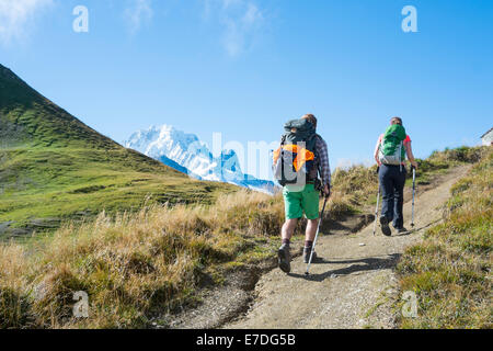 COL DE BALME, FRANCE - SEPTEMBER 01: Backpackers walking on trail with Mont Blanc in the background. The area is a stage of the Stock Photo