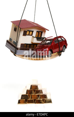 Architectural model,car model and gold bars Stock Photo