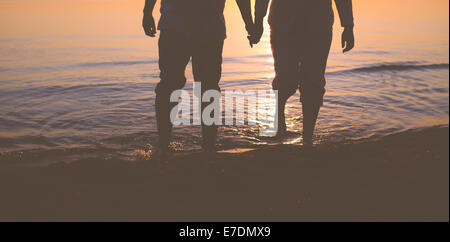 Senior couple walking at sunset Stock Photo