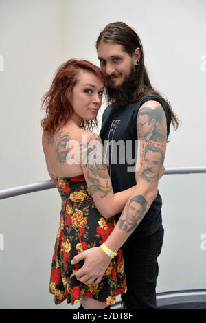 Garden City, New York, USA. 14th Sep, 2014. PAT SULLY and CATERINA, of Massapequa, are at the United Ink Flight 914 tattoo convention at the Cradle of Aviation museum of Long Island. Later that night, Caterina was suspended from two ropes with hooks pierced through the skin of her back, at the outdoor body suspension show. Credit:  Ann Parry/ZUMA Wire/Alamy Live News Stock Photo