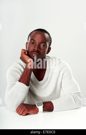 Portrait of a thoughtful african man sitting at the table Stock Photo