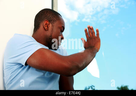 Portrait of african man looking at window Stock Photo