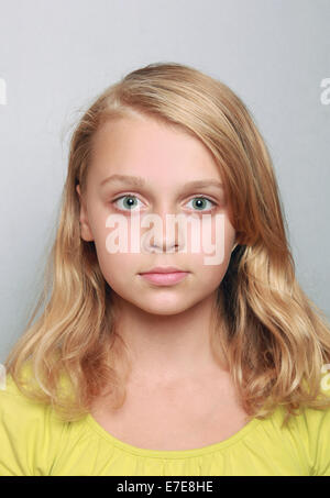 Caucasian little girl closeup portrait. Headshot on gray Stock Photo