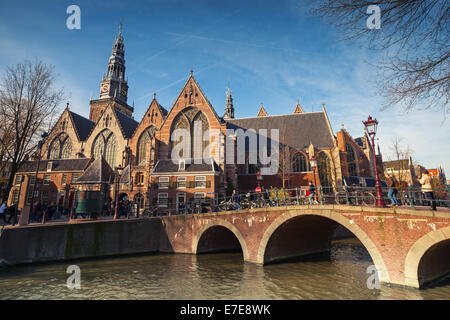 AMSTERDAM, NETHERLANDS - MARCH 19, 2014: Oude Kerk. Old church on the canal coast in Amsterdam Stock Photo