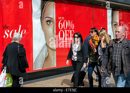 Shoppers walking by Marks & Spencer "60% Off" sale signs on Princes Street, Edinburgh, Scotland. Stock Photo
