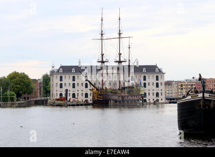 Dutch National Maritime Museum (Scheepvaartmuseum) in Amsterdam, The Netherlands. Replica VOC-ship Amsterdam moored in front. Stock Photo