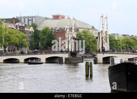 The famous Magere Brug spanning   the river Amstel in the city centre of Amsterdam, The Netherlands, open to let a ship pass Stock Photo