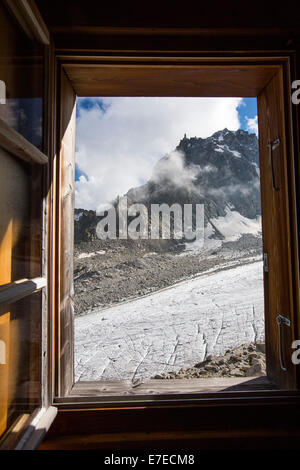 The rapidly receding Glacier D' Orny from a window of Cabanne D' Orny in the Swiss Alps, a mountain hut at over 10,000 feet. Stock Photo