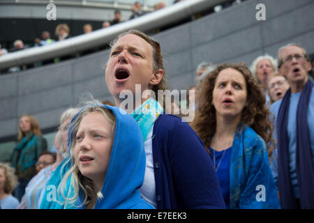 Adults choir, made from choirs from all over the region, perform at The Scoop. Totally Thames Festival, London, UK. Stock Photo