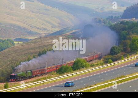 Steam train locomotive to the M6 motorway in the River Lune Valley. Howgills, Cumbria, West Coast Main Line, England, UK. Stock Photo