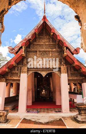 Ancient viharn of lanna style temple with the very beautiful carving decoration on the facade Stock Photo