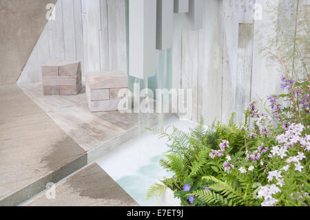 Garden - A Garden of Solitude - contemporary pergola with garden made from recycled and reused materials Stock Photo