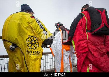 Base jumpers wearing wing suites prepare to jump from the Aiguille Du midi above Chamonix, France. Stock Photo