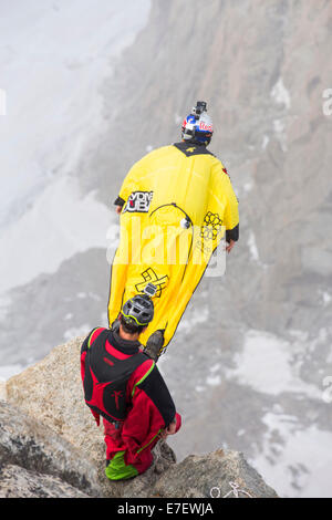 Base jumpers wearing wing suites jump from the Aiguille Du midi above Chamonix, France. Stock Photo