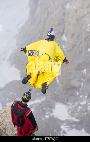 Base jumpers wearing wing suites jump from the Aiguille Du midi above Chamonix, France. Stock Photo