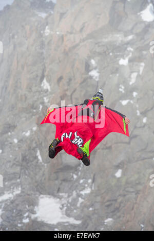 Base jumpers wearing wing suites jump from the Aiguille Du midi above Chamonix, France. Stock Photo