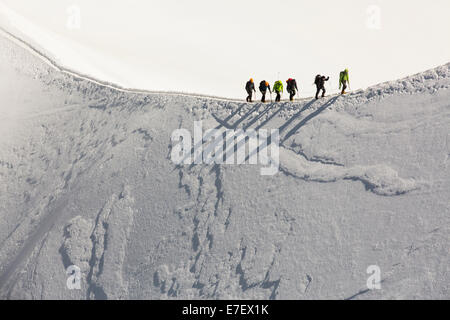 Climbers on the arete leading up from the Vallee Blanche to the Aiguille Du Midi above Chamonix, France. Stock Photo