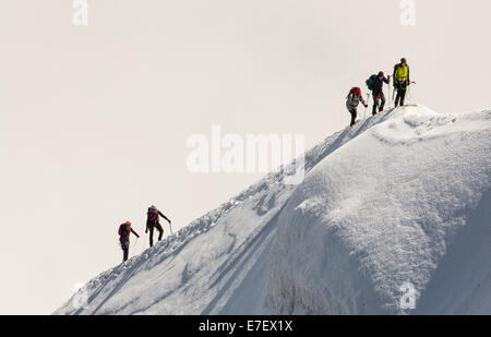 Climbers on the arete leading up from the Vallee Blanche to the Aiguille Du Midi above Chamonix, France. Stock Photo