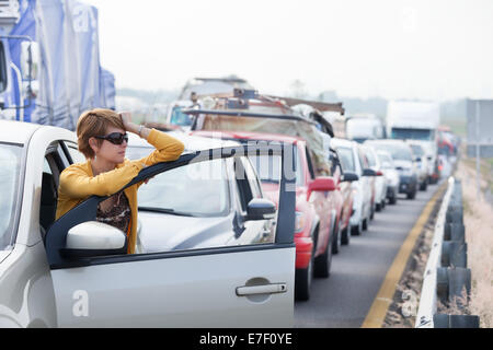 Frustrated middle aged Hispanic woman stuck in a traffic jam. Stock Photo