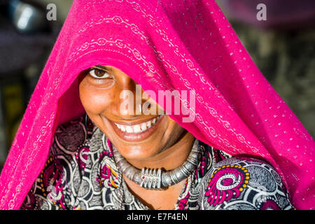 A smiling young woman wearing a pink veil, Mumbai, Maharashtra, India Stock Photo