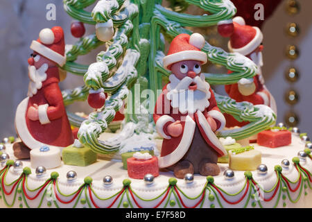 Santa Claus figures made of marzipan, decoration on a cake, in the window of a pastry shop, Düsseldorf, North Rhine-Westphalia Stock Photo