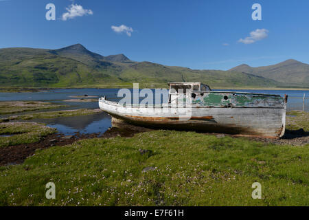 Old fishing boat, boat wreck in the bay, Munro Mountain, Argyll, Isle of Mull, Scotland, United Kingdom Stock Photo