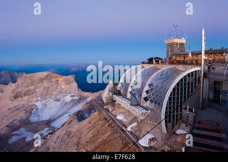 Summit plateau of Mt Zugspitze with a terrace and Münchner Haus mountain hut, at dawn before sunrise, Bavaria, Germany Stock Photo