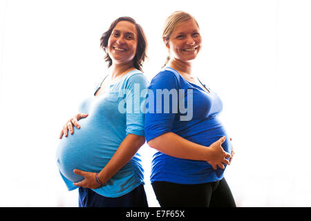 Pregnant women holding their bellies Stock Photo