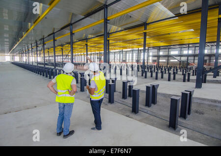 Workers examining warehouse Stock Photo