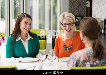 Caucasian women talking in restaurant Stock Photo