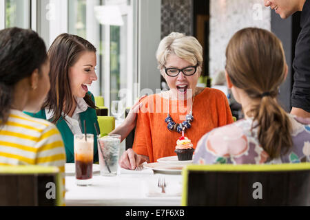 Women celebrating birthday in restaurant Stock Photo