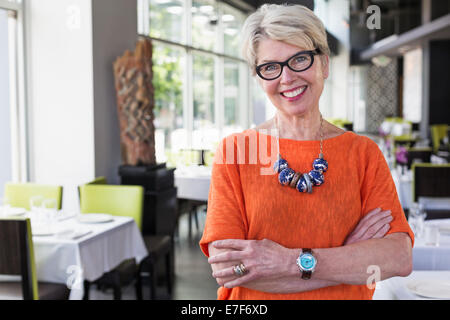 Caucasian woman smiling in restaurant Stock Photo