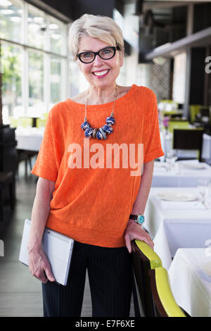 Caucasian woman smiling in restaurant Stock Photo